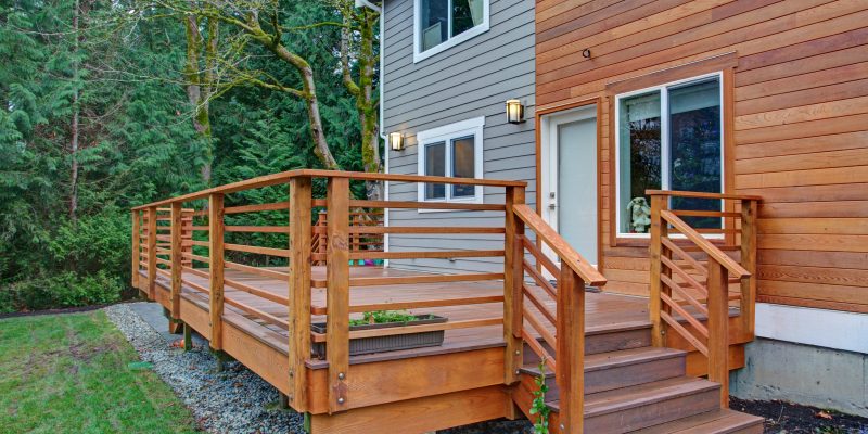 Home with half wood, half vinyl siding, and a beautiful wooden deck