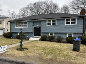 a blue house with new windows and roofing