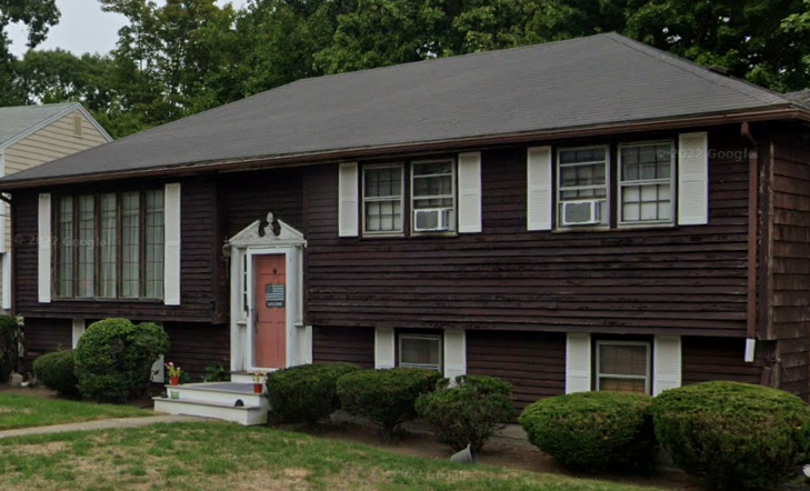 brown house with outdated roofing and siding