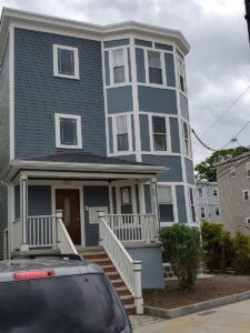 Blue home siding installation in Somerville, MA