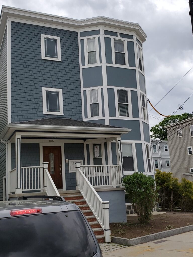 Blue home siding installation in Somerville, MA