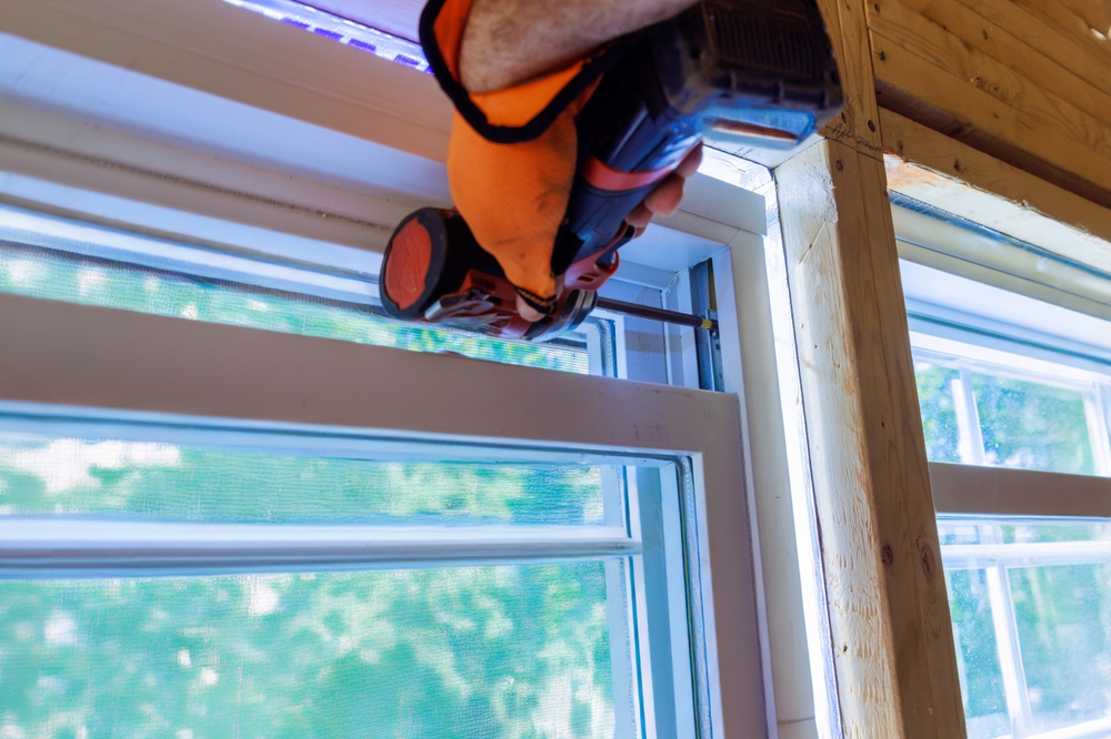 Contractor installing new window on a brand new constructed home