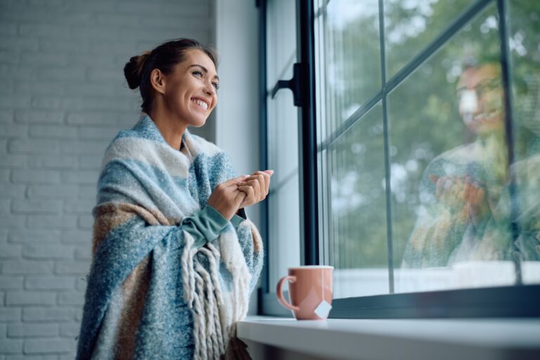 woman by her windows during winter season