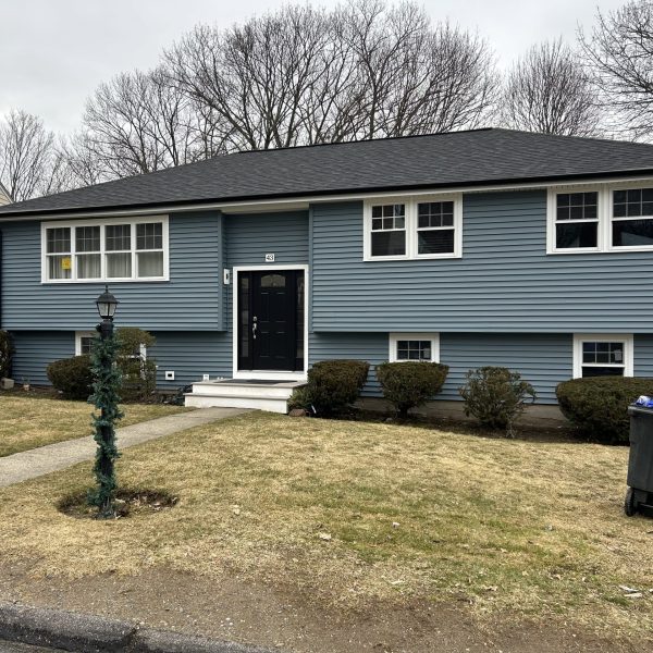 a blue house with new windows and roofing