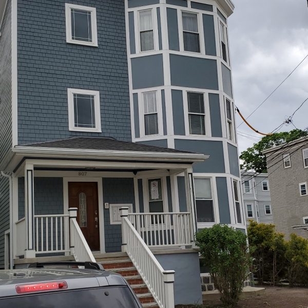 Blue home siding installation in Somerville, MA