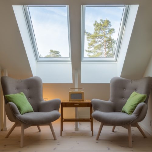 Two skylights with two chairs & table, sitting nook